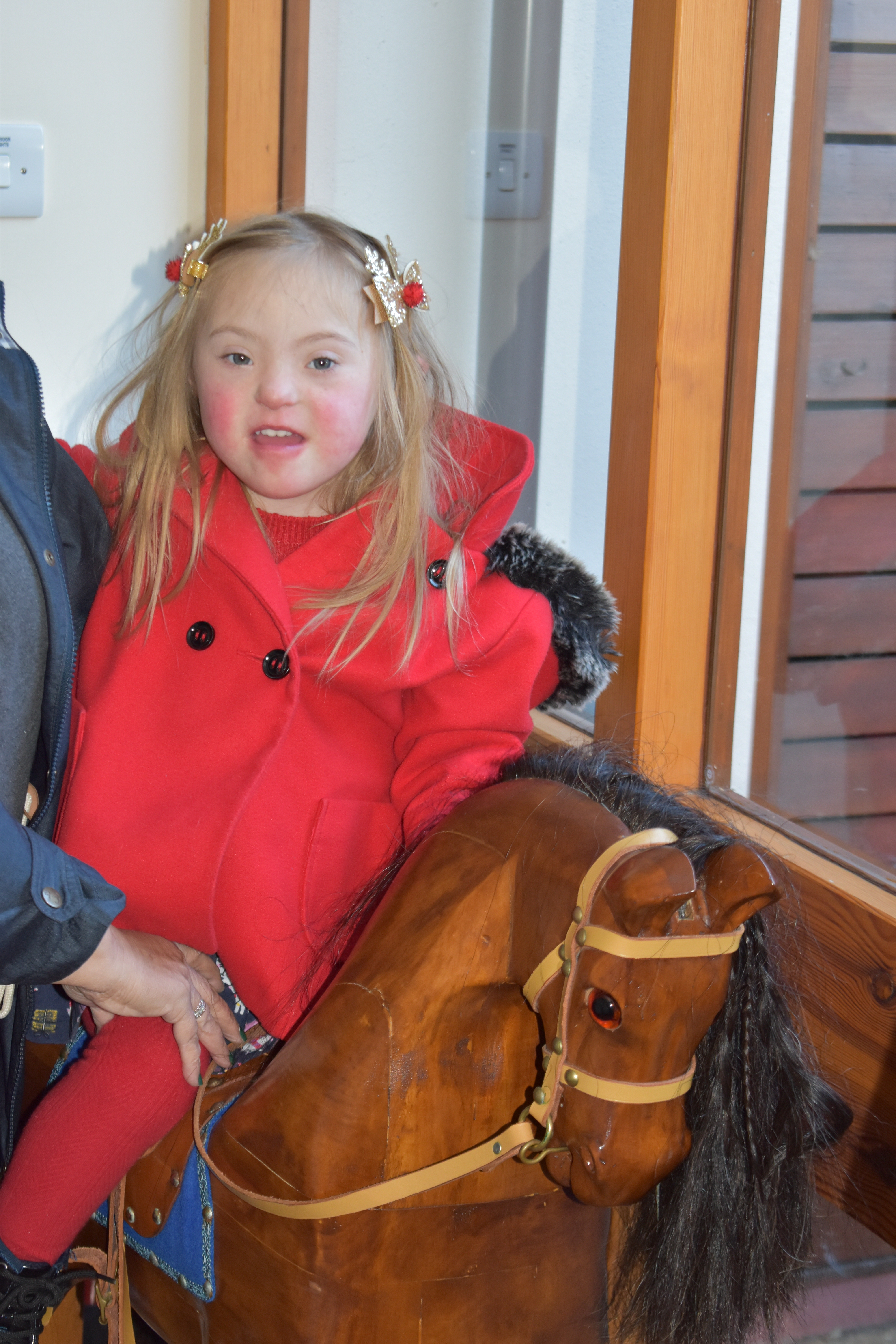 Esme on a rocking horse at Little Bridge House